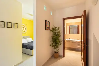 a bedroom and a bathroom with a bed and a mirror at Urban Loft Piramide in Rome