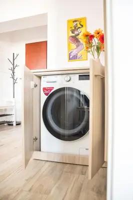 a washing machine in a cabinet in a room at Via Rocca House in Rome