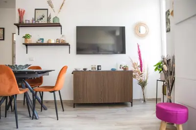 a living room with a tv and a table and chairs at Via Rocca House in Rome