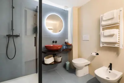 a bathroom with a shower and a sink and a toilet at Elegant Apartment Minelli Navona by GHOR in Rome