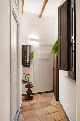 a hallway with a door and a table with flowers at Elegant Apartment Minelli Navona by GHOR in Rome