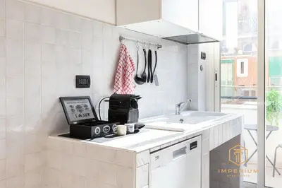 a kitchen with a sink and a toaster on a counter at Teano Apt - 10min to Colosseo, 100mt to metro, A-C, 2 Bedrooms in Rome
