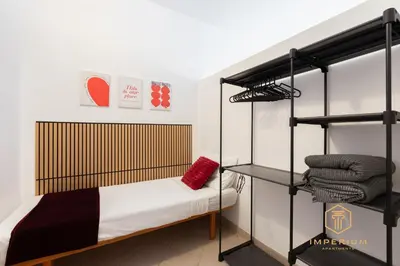 a bedroom with a bunk bed and a shelf at Teano Apt - 10min to Colosseo, 100mt to metro, A-C, 2 Bedrooms in Rome