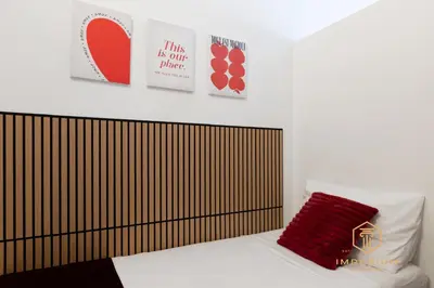 a bedroom with a bed with two posters on the wall at Teano Apt - 10min to Colosseo, 100mt to metro, A-C, 2 Bedrooms in Rome