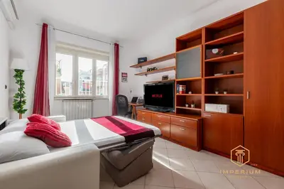 a bedroom with a bed and a flat screen tv at Teano Apt - 10min to Colosseo, 100mt to metro, A-C, 2 Bedrooms in Rome
