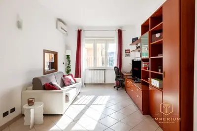 a living room with a couch and a tv at Teano Apt - 10min to Colosseo, 100mt to metro, A-C, 2 Bedrooms in Rome