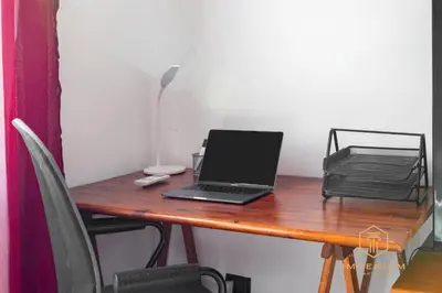 a laptop computer sitting on a desk with a printer at Teano Apt - 10min to Colosseo, 100mt to metro, A-C, 2 Bedrooms in Rome