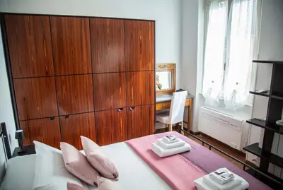 a bedroom with a large bed with two towels on it at La Casa di SilvAnna in Rome