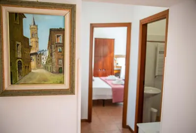 a painting on a wall next to a bedroom at La Casa di SilvAnna in Rome