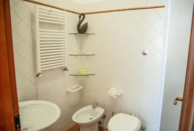 a small bathroom with a toilet and a sink at La Casa di SilvAnna in Rome