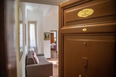 a door to a living room with a couch next to it at La Casa di SilvAnna in Rome