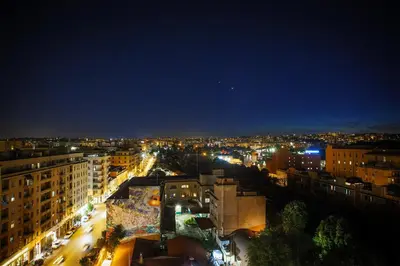 a view of a city at night with lights at City Lights Rome in Rome
