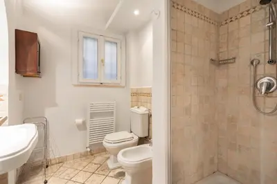 a bathroom with a toilet and a sink and a shower at Trastevere Charming Apartment by RomeLoft in Rome
