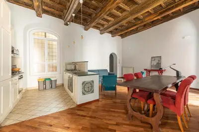 a kitchen and dining room with a table and chairs at Trastevere Charming Apartment by RomeLoft in Rome