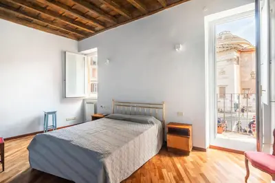 a bedroom with a bed and a large window at Trastevere Charming Apartment by RomeLoft in Rome