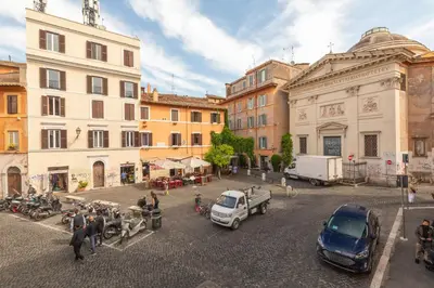 a city street with cars and people and buildings at Trastevere Charming Apartment by RomeLoft in Rome
