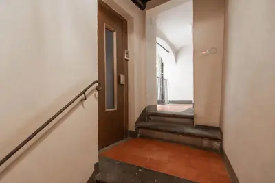 an empty hallway with a stairway with a door and a stairwayngthngth at Trastevere Charming Apartment by RomeLoft in Rome