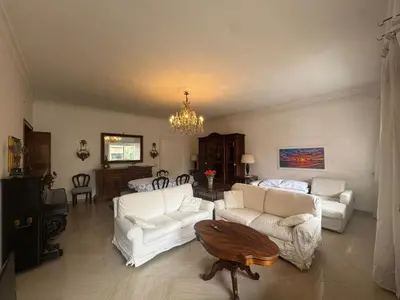 a living room with white furniture and a chandelier at Spacious Getaway with Roman Charm in Rome