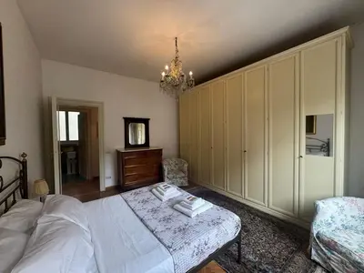 a bedroom with a bed and a chandelier at Spacious Getaway with Roman Charm in Rome