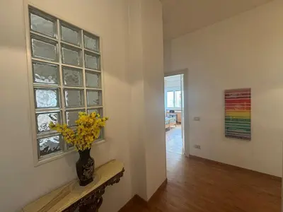 a room with a vase with yellow flowers on a window at Spacious Getaway with Roman Charm in Rome