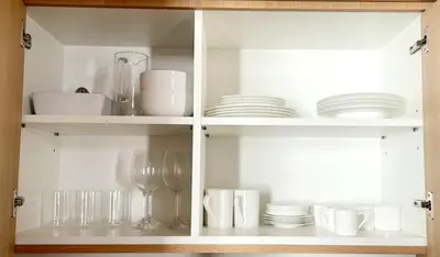 a cabinet filled with plates and glasses and dishes at Design Suite apartment Piazza di Spagna in Rome