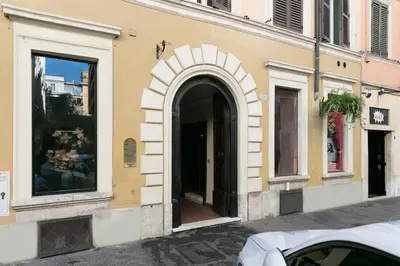 a building with an archway on the side of a street at Design Suite apartment Piazza di Spagna in Rome