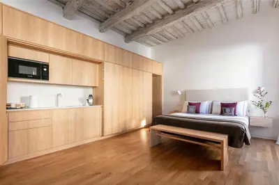 a bedroom with a bed and a tv on a wall at Design Suite apartment Piazza di Spagna in Rome