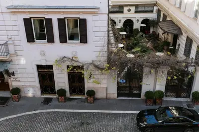 a black car parked in front of a building at Design Suite apartment Piazza di Spagna in Rome