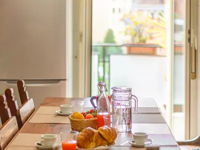 a table with a jug of juice and a basket of fruit at Casa Lo Vercio in Rome