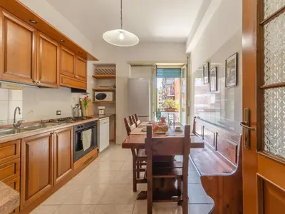 a kitchen with wooden cabinets and a wooden table at Casa Lo Vercio in Rome