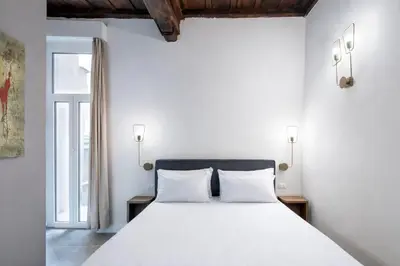 a bedroom with a bed and a mirror at 39 Steps Trevi in Rome