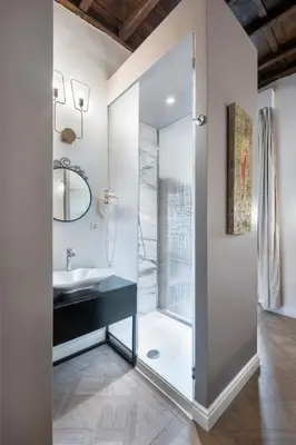 a bedroom with a white bed and a mirror at 39 Steps Trevi in Rome