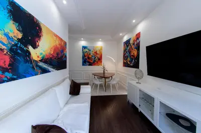 a living room with a large flat screen tv at PapaRoma Suite in Rome
