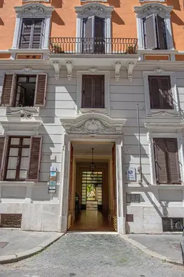 a large white building with a hallway leading to it at PapaRoma Suite in Rome