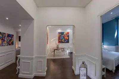 a bedroom with a bed and a table in a room at PapaRoma Suite in Rome