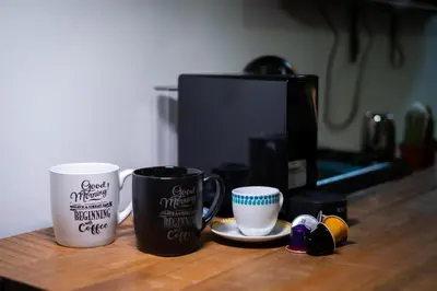 two coffee mugs sitting on top of a counter at Trevi Guesthouse in Rome