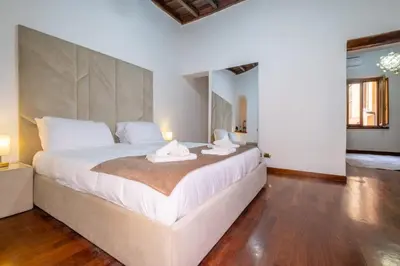 a bedroom with a large bed with two towels on it at Trevi Guesthouse in Rome