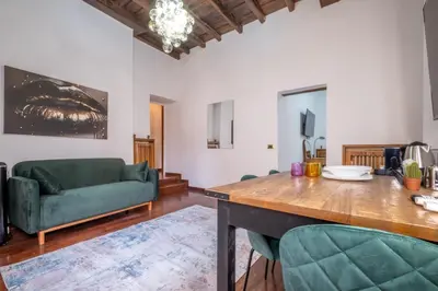 a living room with a green couch and a table at Trevi Guesthouse in Rome