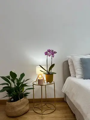 a bedroom with a bed and a table with flowers on it at MarVal Vatican House in Rome