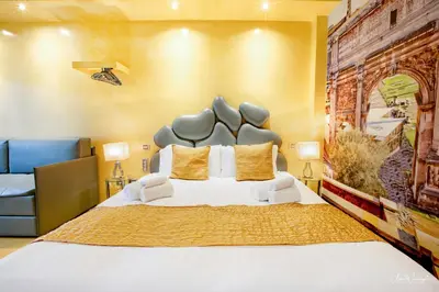 a bedroom with a large bed with a large headboard at Magikrooms Luxury in Rome