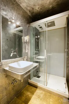 a bathroom with a sink and a shower at Magikrooms Luxury in Rome