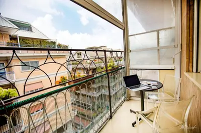 a balcony with a laptop computer sitting on a table at Magikrooms Luxury in Rome