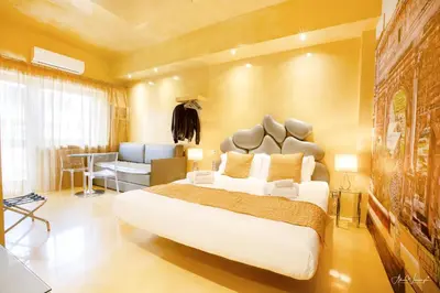 a bedroom with a large bed and a living room at Magikrooms Luxury in Rome