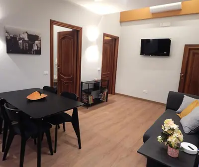 a living room with a table and a couch at Domus Quintili Monti in Rome