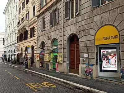 a city street with a building with stores on it at Domus Quintili Monti in Rome