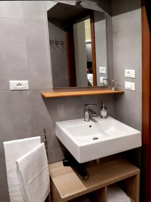 a bathroom with a white sink and a mirror at Domus Quintili Monti in Rome