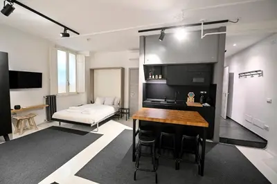 a kitchen and living room with a table and a couch at Why Not Apartment in Rome