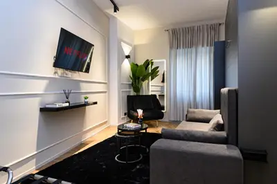 a living room with a couch and a chair at Rome Elegant Suite in Rome