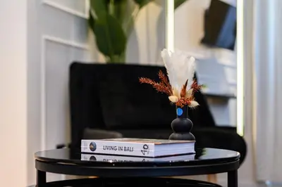 a table with books and a vase on top at Rome Elegant Suite in Rome