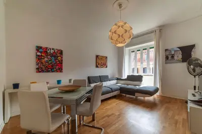 a living room with a table and a couch at GuestHost - Bright Flat in Lungotevere Flaminio in Rome